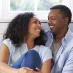 Romantic Couple Relaxing In Chair At Home